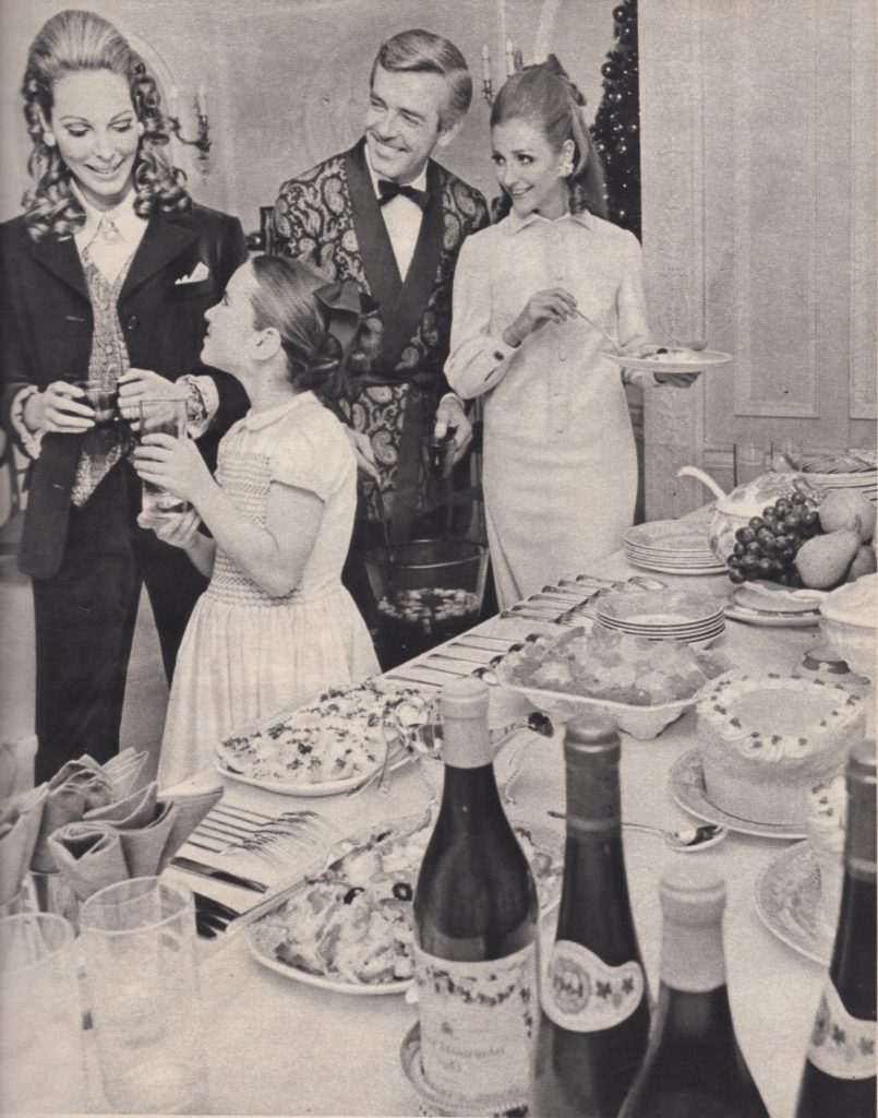 Photo of three adults and a child serving themselves from a buffet table.